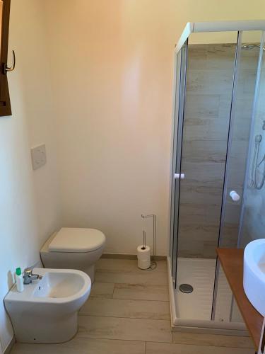 a bathroom with a shower and a toilet and a sink at Villa Vinci in Recanati