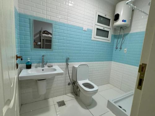 a bathroom with a toilet and a sink at Cairo Pyramids View Hostel & Apartment in Cairo