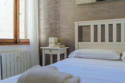 a bedroom with a white bed and a window at Yourbanflat Clock Tower in Padova