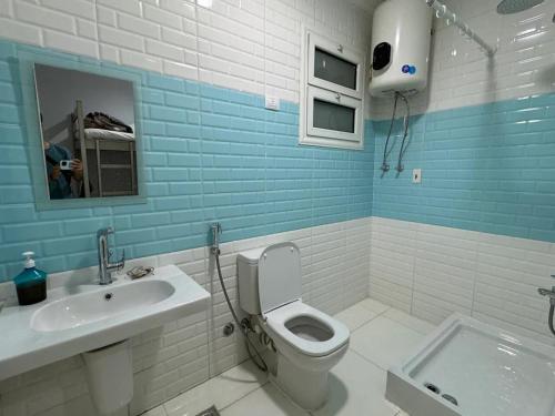 a bathroom with a toilet and a sink at Cairo Pyramids View Hostel & Apartment in Cairo