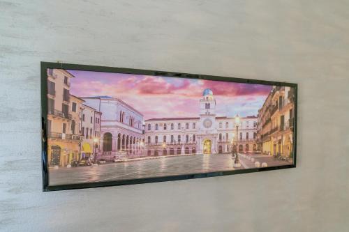 a painting of a building on a wall at Yourbanflat Clock Tower in Padova