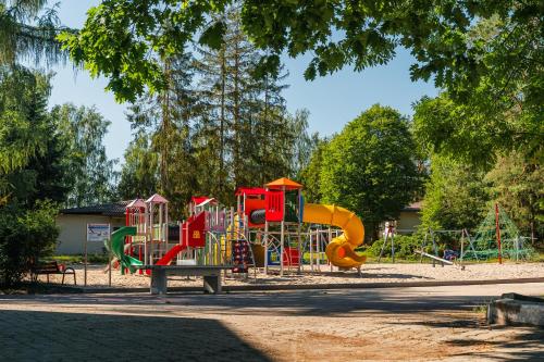 a park with a playground with a slide at Rewita Waplewo in Maróz