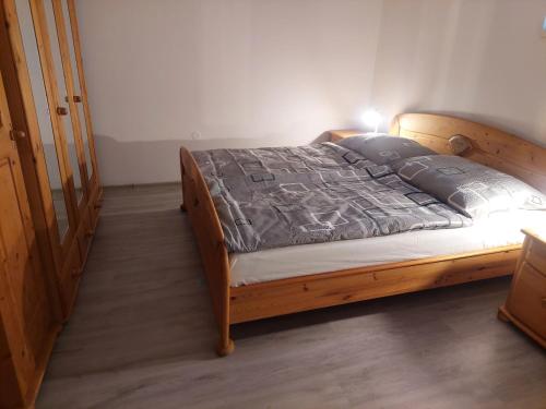 a bedroom with a bed with a wooden frame at Pohoda in Kutná Hora