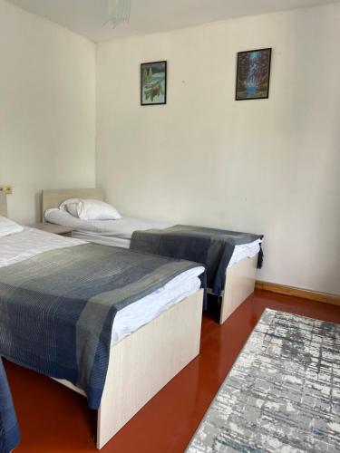 two beds sitting next to each other in a room at Tunuk Guest House in Tossor
