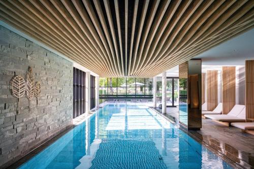 a swimming pool in the middle of a house at Parkhotel Egerner Höfe in Rottach-Egern