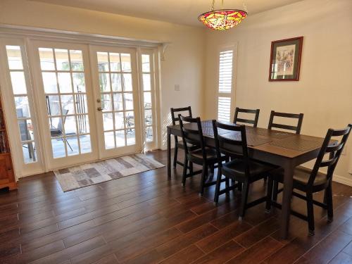 a dining room with a table and chairs at Comfortable home, heated salt-cell pool, 10 min to beach in Sarasota