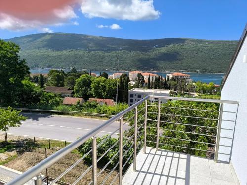 a balcony with a view of a road and mountains at Apartmani Mijović in Herceg-Novi