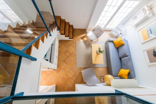 a room with a staircase and yellow cushions at Cabiedes Marina Golf JC in Rota
