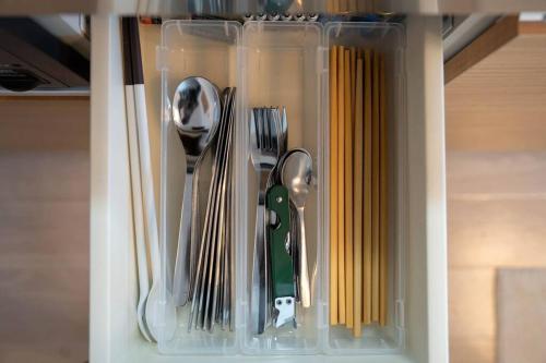 a drawer full of utensils in a drawer at Hotel Hs Park Chitose in Chitose