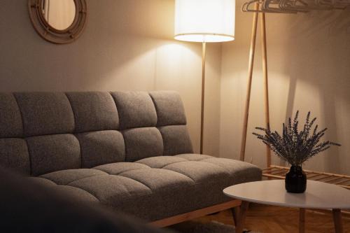 a living room with a couch and a table at Boho Design Studio - Historic City Center with Free Parking & AirCon by HERO HOMES in Graz