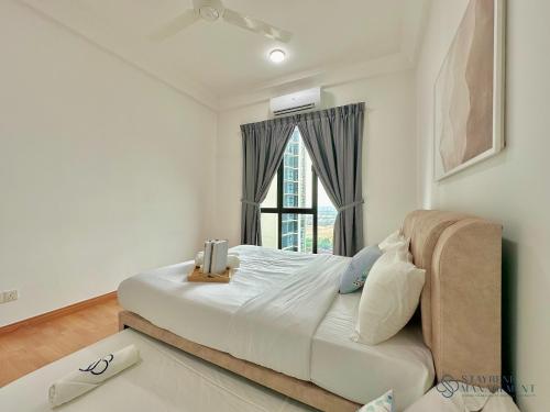 Ένα ή περισσότερα κρεβάτια σε δωμάτιο στο The Platino Near Paradigm Mall By Stayrene