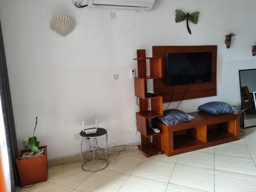 a living room with a flat screen tv on a wall at Lamera in Mombasa