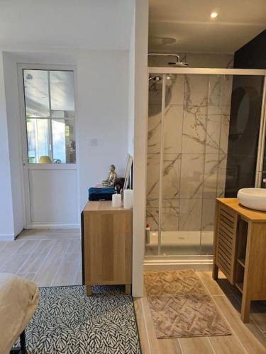 une salle de bain avec une douche à l'italienne et un lavabo dans l'établissement Maison La Plaine, à La Plaine-sur-Mer