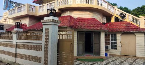 a building with a balcony on top of it at Hotel O Home Crystal Cottage Home Stay in Ayodhya
