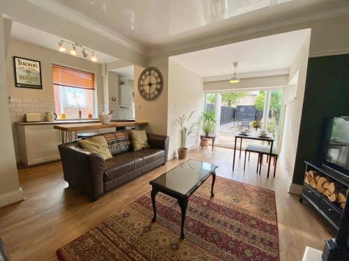 a living room with a couch and a table at Spacious, garden, Netflix, near city in Newcastle upon Tyne