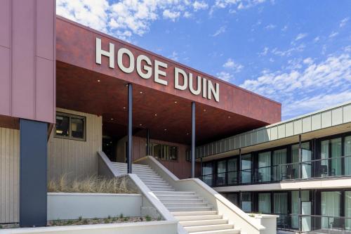 a building with a hoogee dun sign on it at Strandhotel Het Hoge Duin in Wijk aan Zee