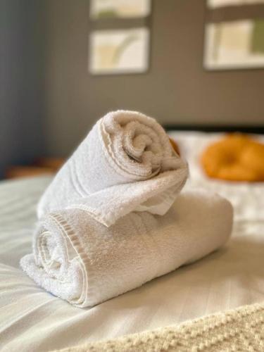 a white towel sitting on top of a bed at Spacious, garden, Netflix, near city in Newcastle upon Tyne