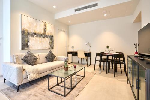 a living room with a couch and a table at Luxury Apartment with Panoramic Sea views in Mercury Towers in St. Julianʼs