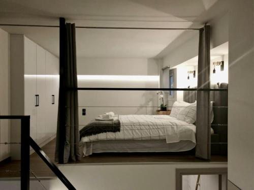 a bedroom with a bed with a large mirror at Cosy Loft in Patra