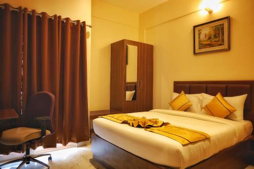 a bedroom with a bed with a robe on it at JN Residency Perungudi in Chennai