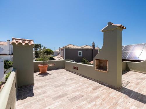 a patio with a fireplace on a roof at Walk in Hostel Faro Airport in Faro