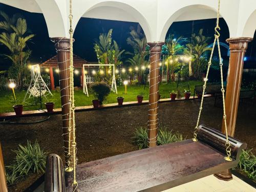 a swing in a garden at night at Coconut Creek Homestay Kumarakom in Kottayam