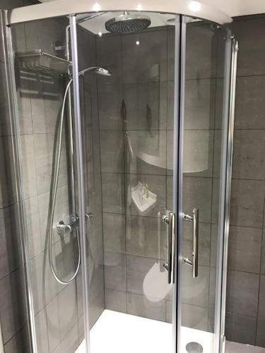 a shower with a glass door in a bathroom at Casa Rosa, Notting Hill in London