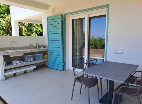 a kitchen with a table and chairs on a patio at Villa Agapanto in Paestum