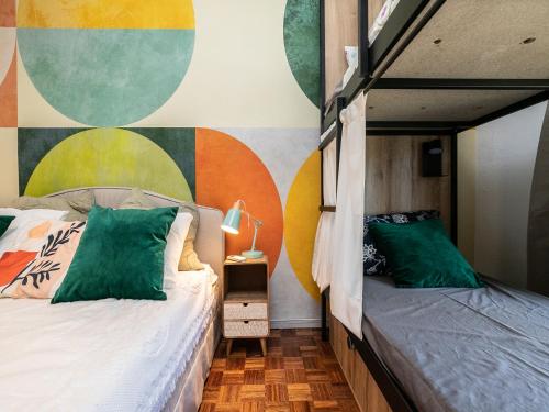 a bedroom with two beds and a mural on the wall at Walk in Hostel Faro Airport in Faro