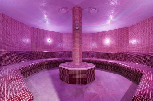 a room with a hot tub with purple lighting at Hotel Slovakia in Trenčianske Teplice