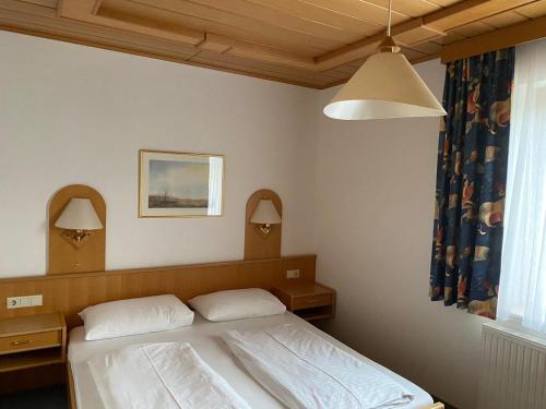a bedroom with a bed with two pillows at Die Herberge in Podersdorf am See