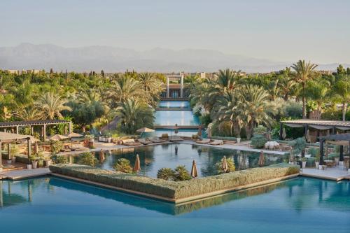 an aerial view of a resort with palm trees and a pool at Mandarin Oriental, Marrakech in Marrakech