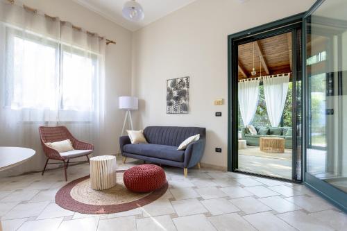 a living room with a couch and a chair at Tenuta Concamarau in Muro Leccese