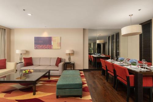 a living room with a couch and a table at Sathorn Vista, Bangkok - Marriott Executive Apartments in Bangkok