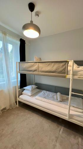 two bunk beds in a room with a light at Hotel Dolce Vita in Balatonkenese