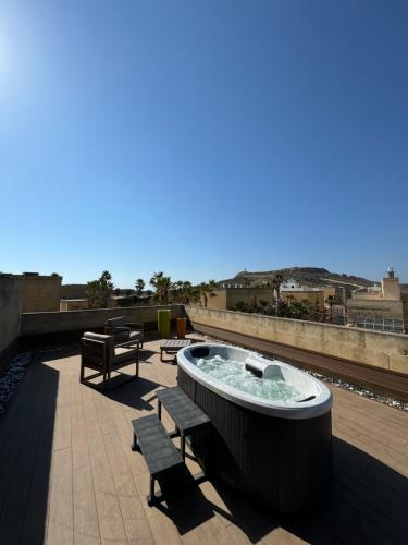 a hot tub on the roof of a building at Maria's B&B in Għasri