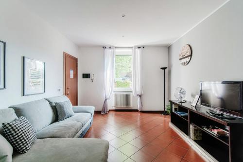 a living room with a couch and a television at La Casa di Nice by Quokka 360 - in the centre of Cernobbio in Cernobbio