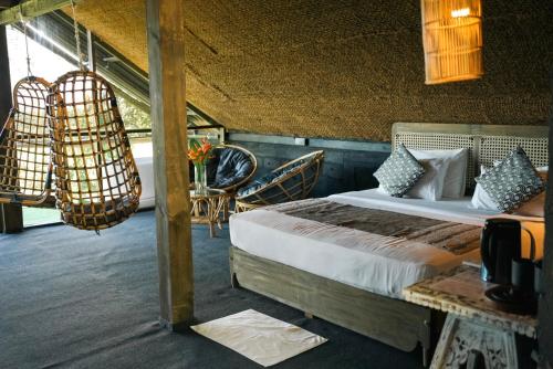 a bedroom with a bed and a table and chairs at Villa Hillcrest in Weligama