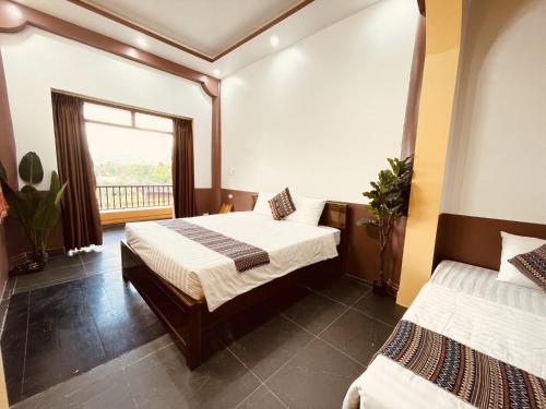 a bedroom with two beds and a window at Sky Bay Lodge in Ha Giang