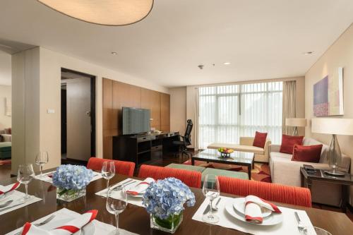 a living room with a couch and a table at Sathorn Vista, Bangkok - Marriott Executive Apartments in Bangkok