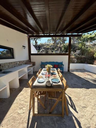 a wooden table in the middle of a patio at Casanova Country Villa in Santo António das Areias