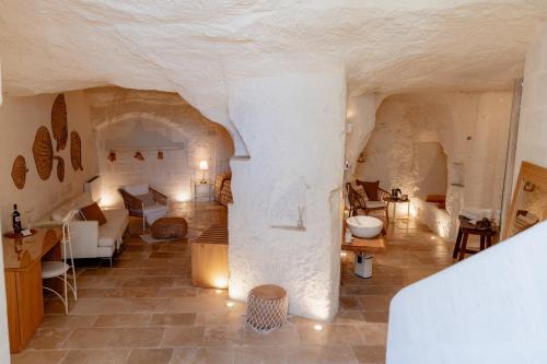 a large room with a stone wall and a living room at Il Belvedere in Matera