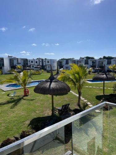 a view of a resort with umbrellas and a pool at VILLA cHELSEA 2 bed room in Grand Gaube
