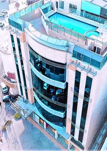 a building with a swimming pool on top of it at Milana Serviced Apartments in Jeddah