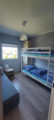 Postel nebo postele na pokoji v ubytování RESET domki letniskowe