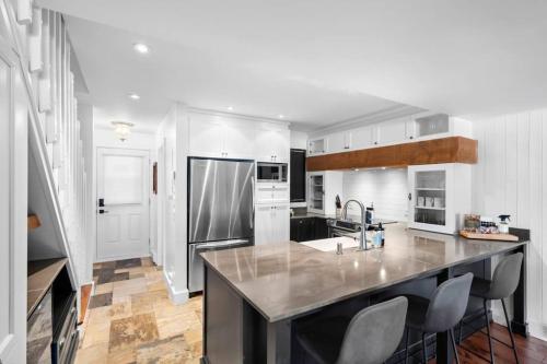 a kitchen with a large island in the middle at The Mountain View Condo in Mont-Tremblant