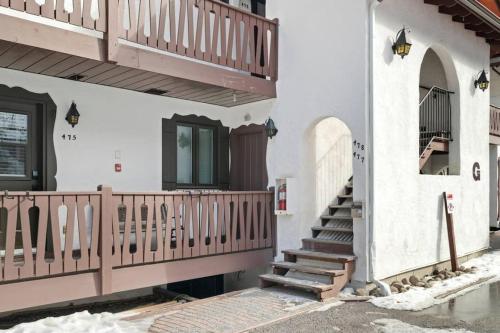 a house with a staircase and a balcony at The Mountain View Condo in Mont-Tremblant