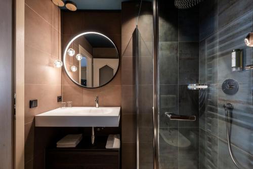 a bathroom with a sink and a shower at Post Hotel - Tradition & Lifestyle Adults Only in San Candido