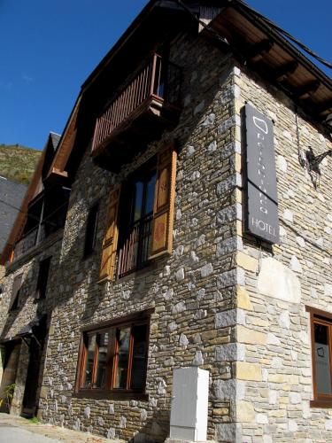 a stone building with a sign on the side of it at Peira Blanca Hotel Gastronómico in Garós
