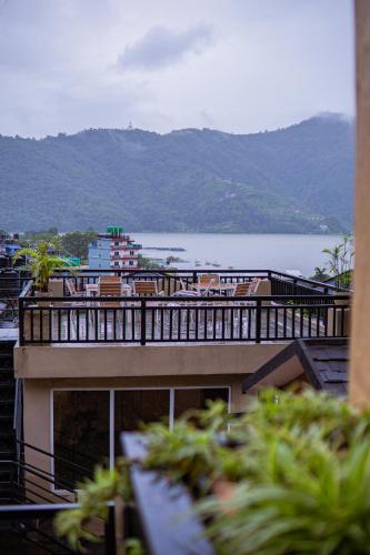 a building with a view of a body of water at Pokhara Boutique Hotel in Pokhara